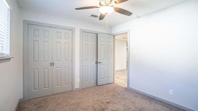 1031 Oak Hurst Dr, Grapevine, TX 76051 - unfurnished bedroom featuring carpet flooring, multiple closets, and a ceiling fan
