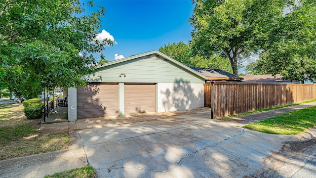 1031 Oak Hurst Dr, Grapevine, TX 76051 - view of property exterior featuring brick siding, a detached garage, and an outdoor structure