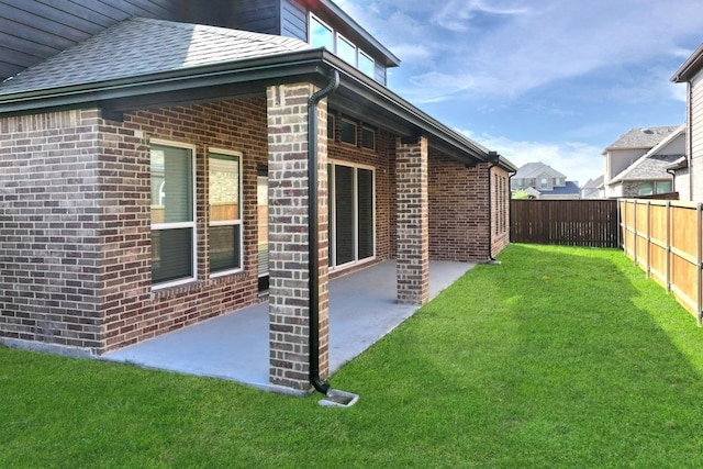 1032 Meadowlark, Forney, TX 75126 - view of property exterior featuring brick siding, a fenced backyard, a patio, and roof with shingles