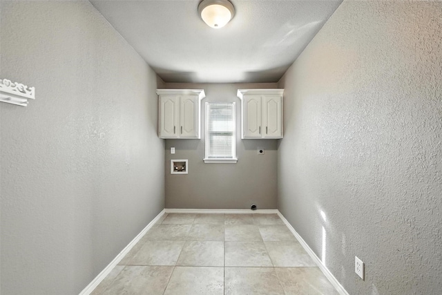 1208 Homestead St, Flower Mound, TX 75028 - laundry room with electric dryer hookup, washer hookup, a textured wall, light tile patterned flooring, and cabinet space