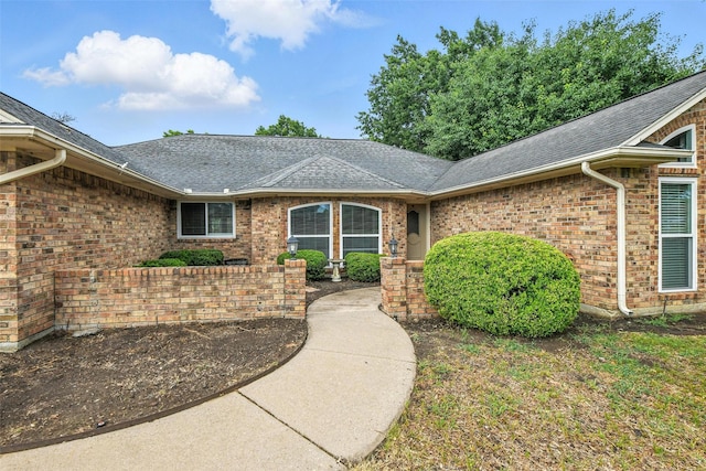 1208 Homestead St, Flower Mound, TX 75028 - view of exterior entry with brick siding and a shingled roof
