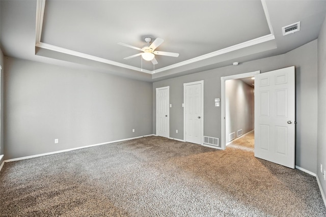 1208 Homestead St, Flower Mound, TX 75028 - unfurnished bedroom with a tray ceiling, carpet floors, crown molding, a ceiling fan, and two closets
