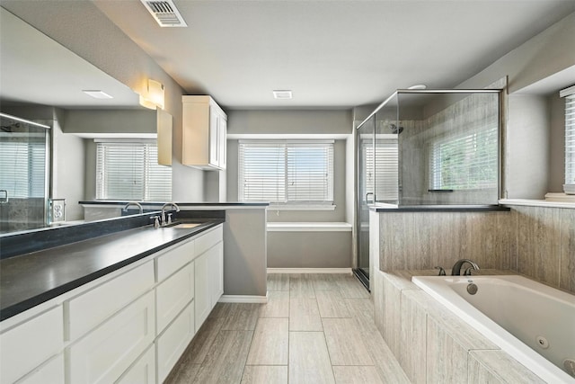 1208 Homestead St, Flower Mound, TX 75028 - full bath with a tub with jets, a shower stall, vanity, and wood tiled floors