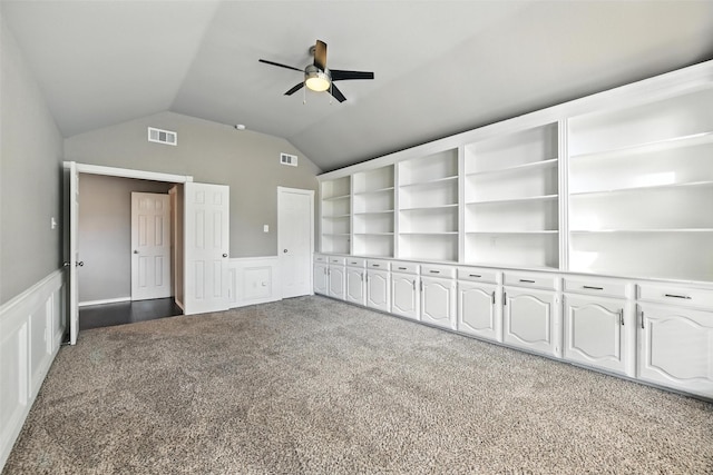 1208 Homestead St, Flower Mound, TX 75028 - unfurnished bedroom featuring light carpet, lofted ceiling, wainscoting, a decorative wall, and ceiling fan