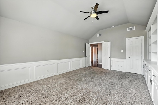 1208 Homestead St, Flower Mound, TX 75028 - unfurnished bedroom with carpet floors, vaulted ceiling, a wainscoted wall, a decorative wall, and a ceiling fan
