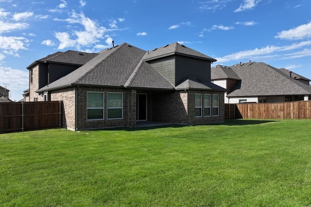 850 Blue Heron Dr, Forney, TX 75126 - rear view of property featuring a fenced backyard, a shingled roof, and brick siding