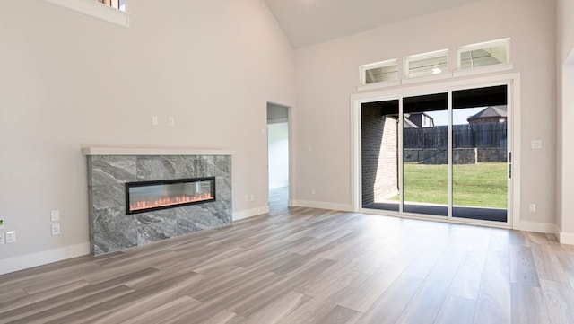 850 Blue Heron Dr, Forney, TX 75126 - unfurnished living room featuring a fireplace, high vaulted ceiling, and wood finished floors