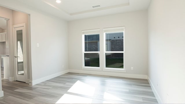 850 Blue Heron Dr, Forney, TX 75126 - spare room featuring light wood-style flooring, a raised ceiling, and recessed lighting