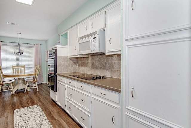 5714 Stage Line Dr, Arlington, TX 76017 - kitchen featuring black appliances, white cabinets, dark wood-style flooring, decorative backsplash, and hanging light fixtures