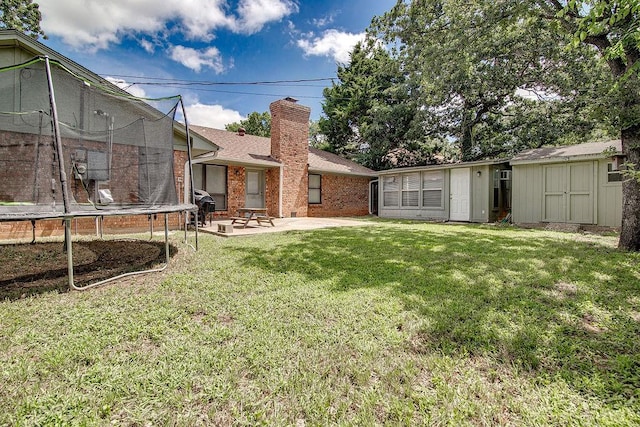 5714 Stage Line Dr, Arlington, TX 76017 - view of green lawn featuring a trampoline, a patio, and a storage shed