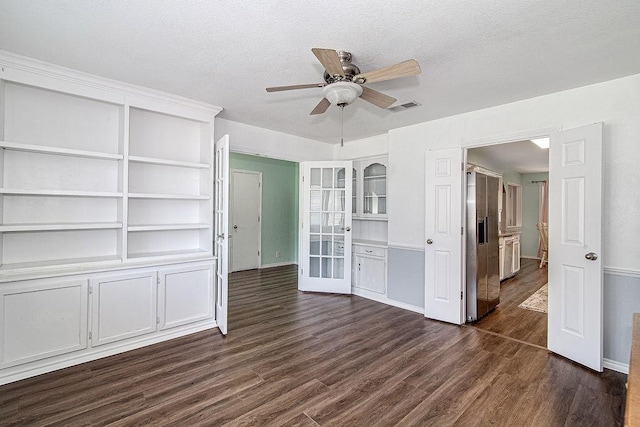 5714 Stage Line Dr, Arlington, TX 76017 - unfurnished bedroom featuring dark wood-style floors, a textured ceiling, french doors, a ceiling fan, and high end fridge