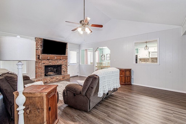 5714 Stage Line Dr, Arlington, TX 76017 - living area featuring wood finished floors, a ceiling fan, vaulted ceiling, and a brick fireplace