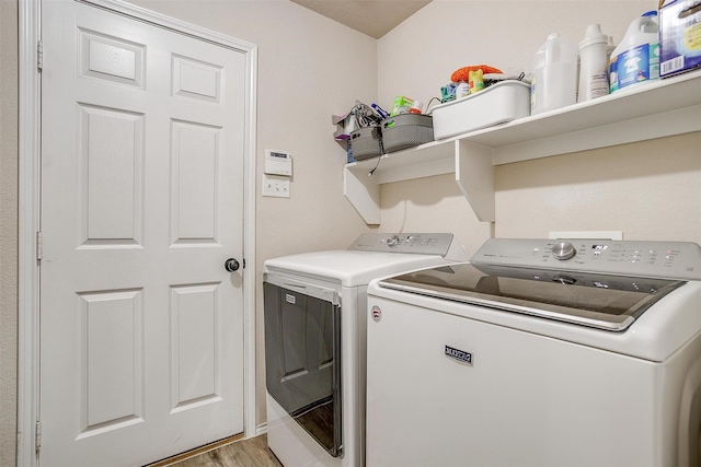 953 Mesa Vista Dr, Crowley, TX 76036 - laundry area with washer and clothes dryer and light wood-style flooring