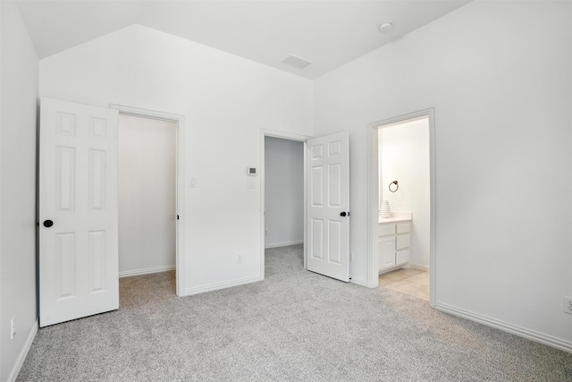 1312 Bluebell Ave, Lantana, TX 76226 - unfurnished bedroom featuring light colored carpet, a walk in closet, lofted ceiling, and ensuite bathroom