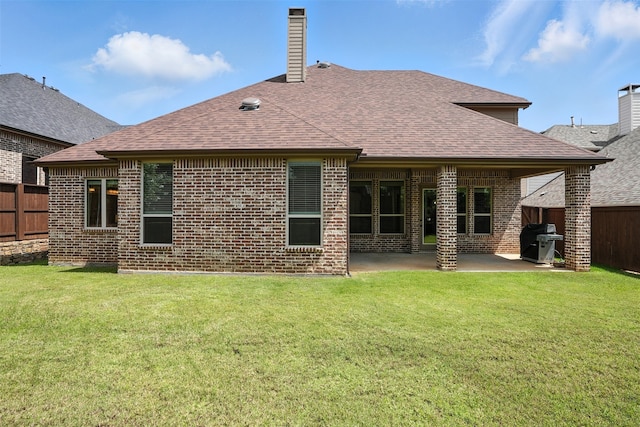 1312 Bluebell Ave, Lantana, TX 76226 - back of house featuring a fenced backyard, brick siding, a shingled roof, a patio area, and a chimney