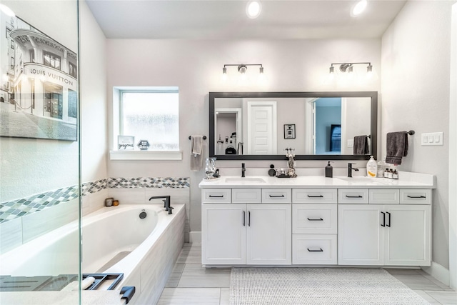 3604 Chapman Cir, Rowlett, TX 75089 - bathroom featuring double vanity, a bath, and recessed lighting