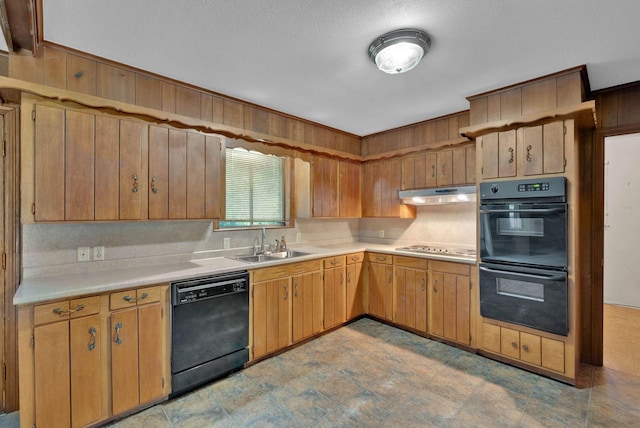 3053 Pines Rd, Shreveport, LA 71119 - kitchen with black appliances, under cabinet range hood, light countertops, and wood walls