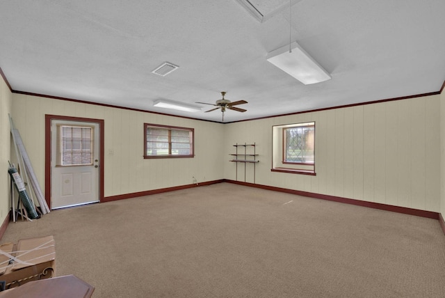 3053 Pines Rd, Shreveport, LA 71119 - unfurnished room featuring carpet flooring, crown molding, a ceiling fan, and wooden walls