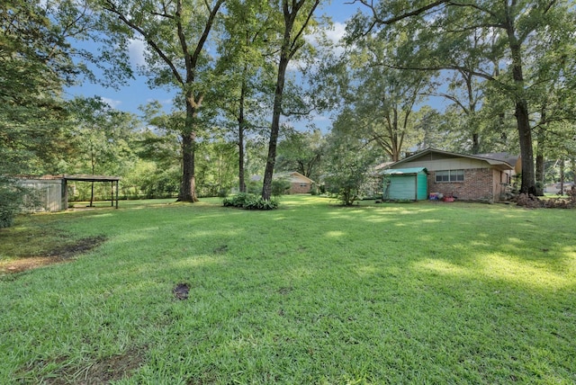 3053 Pines Rd, Shreveport, LA 71119 - view of green lawn with a garage and a carport