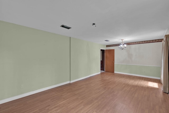 3053 Pines Rd, Shreveport, LA 71119 - empty room with a chandelier and wood finished floors