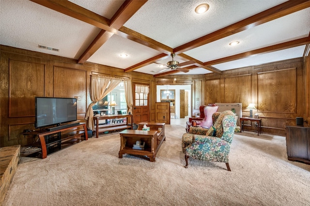 4645 Pecan Place Dr, Mckinney, TX 75071 - carpeted living area with a textured ceiling, wooden walls, beamed ceiling, and ceiling fan