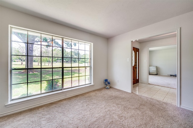 4645 Pecan Place Dr, Mckinney, TX 75071 - unfurnished room with light carpet, healthy amount of natural light, and light tile patterned flooring