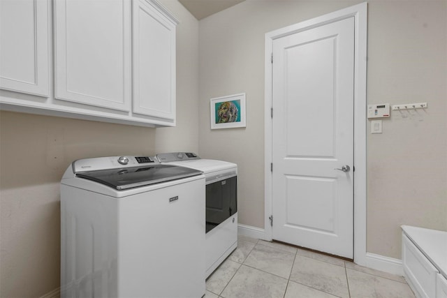 5705 Heron Dr E, Colleyville, TX 76034 - laundry area featuring washer and dryer, cabinet space, and light tile patterned floors