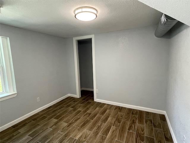 629 Kimbrough St, White Settlement, TX 76108 - empty room with dark wood-type flooring and a textured ceiling