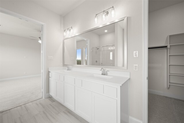 2413 Rams Horn, Waxahachie, TX 75167 - bathroom with a ceiling fan, a shower stall, double vanity, and a spacious closet