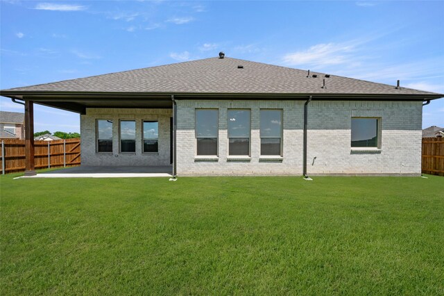2413 Rams Horn, Waxahachie, TX 75167 - rear view of house featuring a patio, a shingled roof, and brick siding