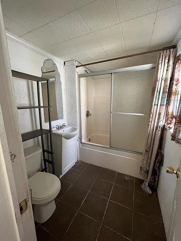 705 W Green St, Palestine, TX 75801 - full bath featuring tile patterned flooring, vanity, and bath / shower combo with glass door