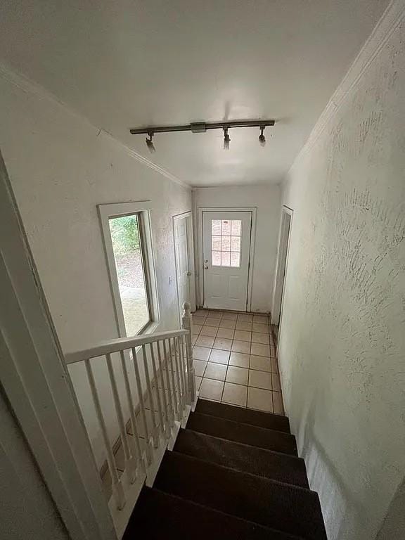 705 W Green St, Palestine, TX 75801 - stairway with track lighting, a textured wall, and crown molding