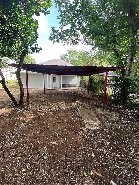 705 W Green St, Palestine, TX 75801 - view of parking / parking lot featuring a carport