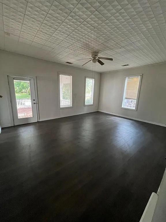 705 W Green St, Palestine, TX 75801 - spare room with plenty of natural light, ceiling fan, and a paneled ceiling
