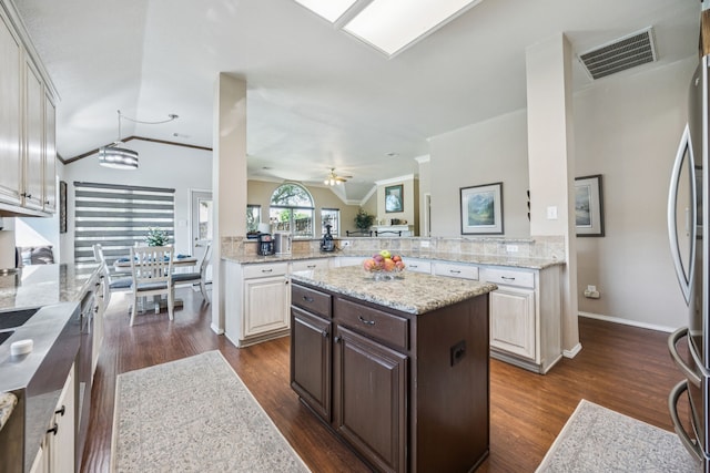 4003 Randall Ln, Carrollton, TX 75007 - kitchen featuring dark brown cabinets, appliances with stainless steel finishes, dark wood finished floors, a ceiling fan, and ornamental molding