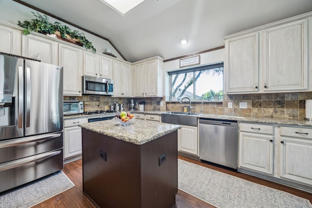 4003 Randall Ln, Carrollton, TX 75007 - kitchen featuring stainless steel appliances, vaulted ceiling, dark wood finished floors, and backsplash