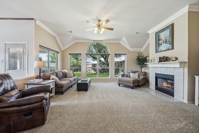 4003 Randall Ln, Carrollton, TX 75007 - living area with a tiled fireplace, a ceiling fan, vaulted ceiling, carpet floors, and ornamental molding