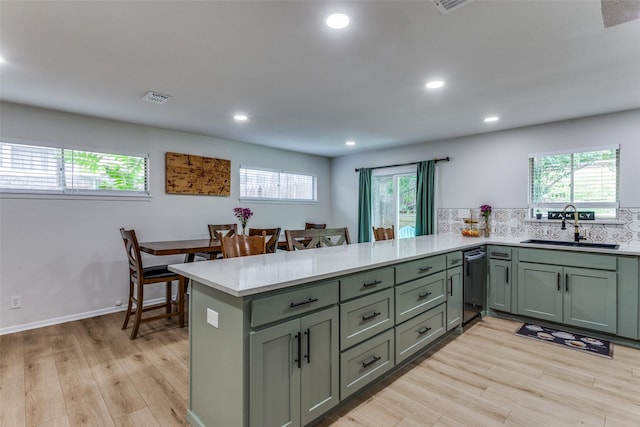 4105 Micki Lynn Ave, Fort Worth, TX 76107 - kitchen with black dishwasher, light countertops, a peninsula, light wood-type flooring, and recessed lighting