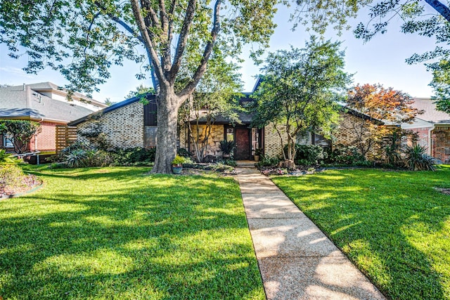 1705 Yorkshire Dr, Richardson, TX 75082 - view of front of home featuring brick siding and a front yard