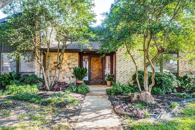 1705 Yorkshire Dr, Richardson, TX 75082 - view of front of property featuring stone siding, a porch, brick siding, and roof with shingles