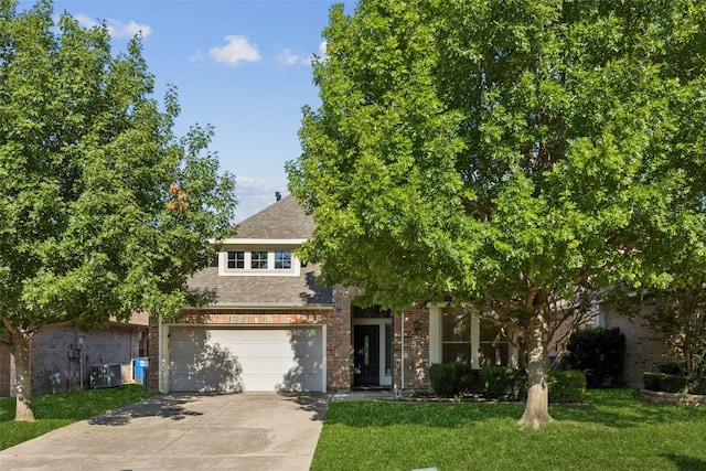 2930 Coteau Way, Dallas, TX 75227 - obstructed view of property with concrete driveway, a front yard, brick siding, and a shingled roof