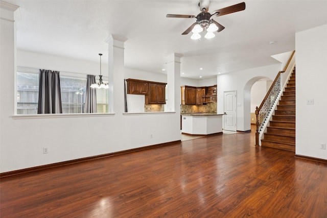 2930 Coteau Way, Dallas, TX 75227 - unfurnished living room with a ceiling fan, arched walkways, dark wood-type flooring, stairway, and recessed lighting