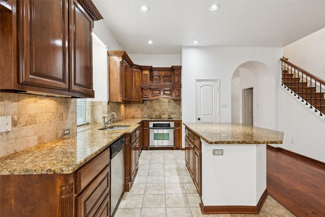 2930 Coteau Way, Dallas, TX 75227 - kitchen featuring stainless steel appliances, a center island, tasteful backsplash, stone countertops, and recessed lighting