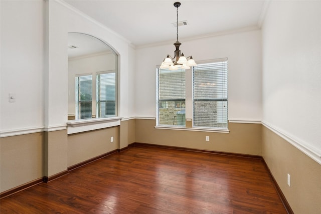 2930 Coteau Way, Dallas, TX 75227 - unfurnished room with a chandelier, plenty of natural light, wood finished floors, crown molding, and arched walkways