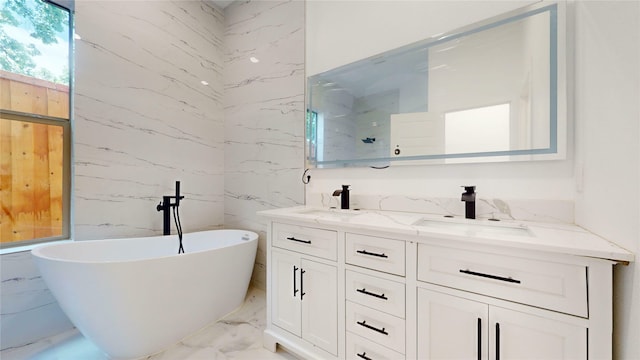 3418 Borger St, Dallas, TX 75212 - bathroom with marble tiled floors, double vanity, a freestanding bath, and tile walls