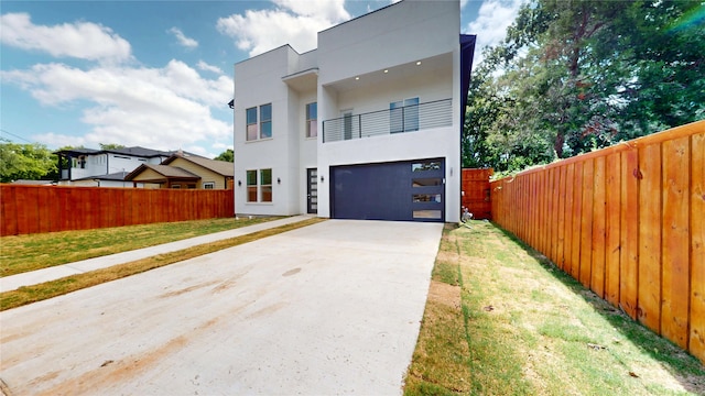 3418 Borger St, Dallas, TX 75212 - modern home featuring a balcony, concrete driveway, stucco siding, and a garage