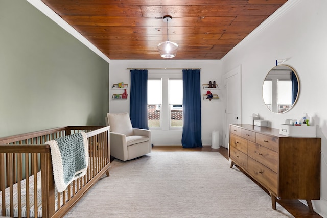 5610 Vanderbilt Ave, Dallas, TX 75206 - bedroom with wood ceiling, crown molding, and a nursery area