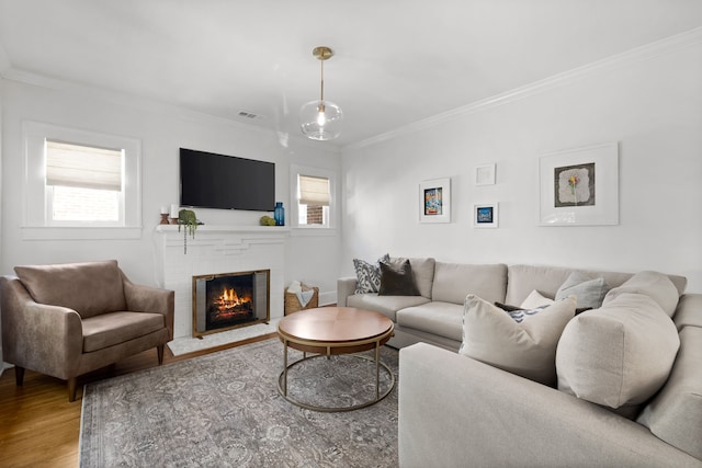 5610 Vanderbilt Ave, Dallas, TX 75206 - living area with wood finished floors, a fireplace, and ornamental molding