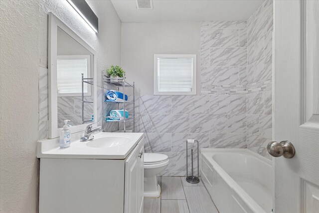25 W Parnell St, Denison, TX 75020 - full bath featuring vanity, tile walls, and a textured wall
