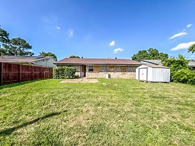 2625 Westview Dr, Mesquite, TX 75150 - back of house featuring a storage shed and stone siding